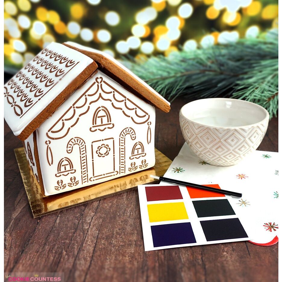 Inhoud van de Gingerbread House Kit met uitstekers, stencils, kwastje en kleurenpalet