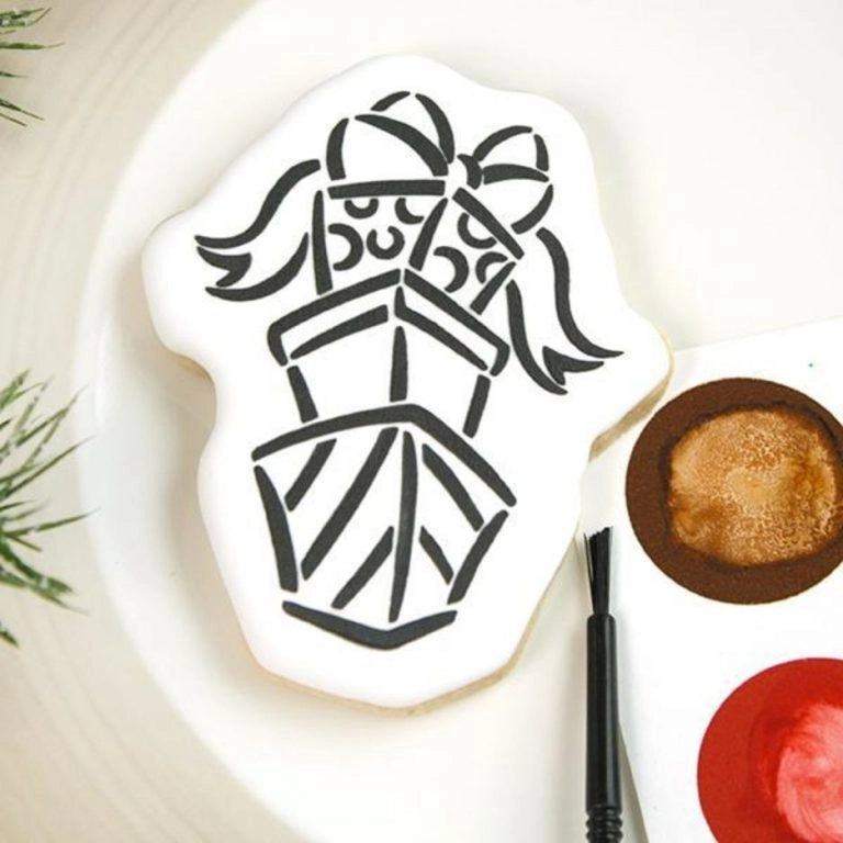 Versierd koekje met The Cookie Countess Present Stack PYO (Paint Your Own) stencil patroon, gestapelde cadeautjes met strik geschilderd in zwart op een wit koekje met eetbare verf en penseel