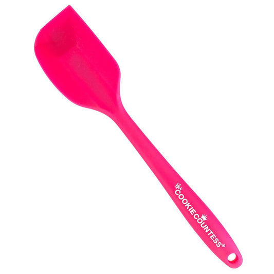 The Cookie Countess siliconen spatula in roze, productafbeelding van de flexibele spatel met The Cookie Countess logo op het handvat, ideaal voor het mengen en aanbrengen van royal icing bij het decoreren van koekjes