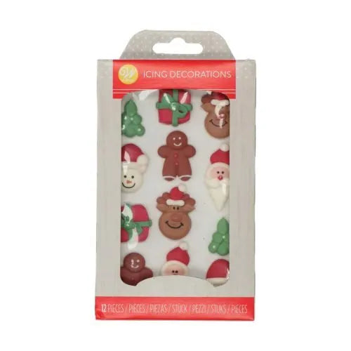 Wilton Kerstfiguurtjes Icing Decorations verpakking met 12 eetbare suikerdecoraties waaronder kerstbomen, peperkoekmannetjes, rendieren, kerstmannen en cadeautjes, perfect voor het versieren van kerstkoekjes en cupcakes